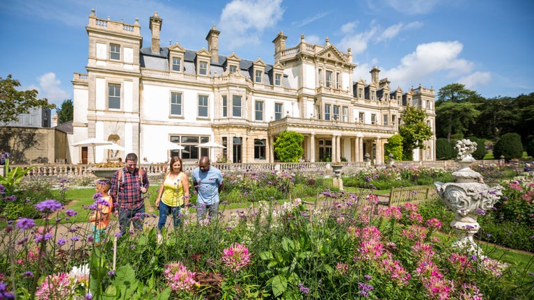 Visitors exploring the gardens during the summer at Dyffryn House, Vale of Glamorgan, Wales